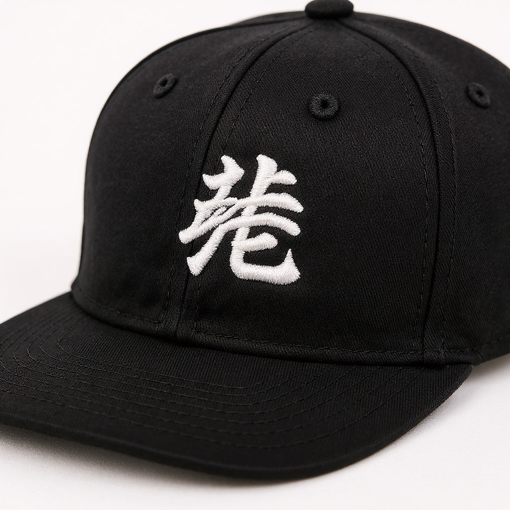 Close-up of embroidered logo detail on Polyester/Cotton Blend Snapback Hat, macro texture shot