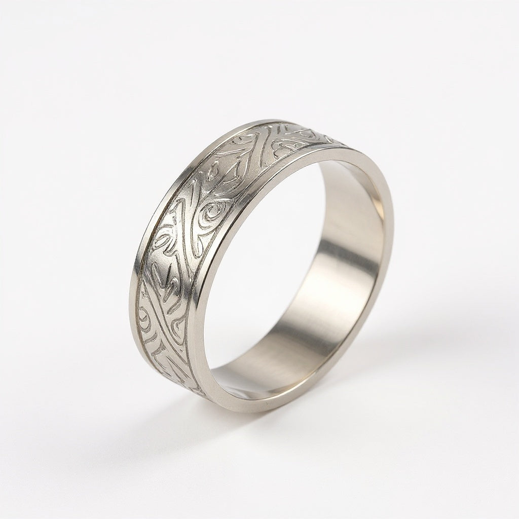 Close-up of engraved detail on sterling silver cuff bracelet, macro texture shot
