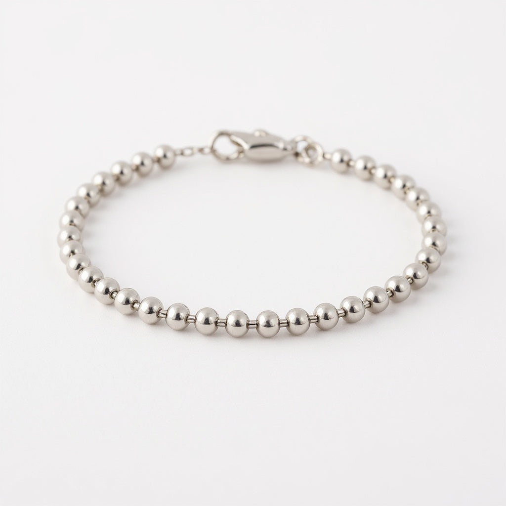 Close-up of delicate bead chain on Sterling Silver Charm Bracelet, macro texture shot